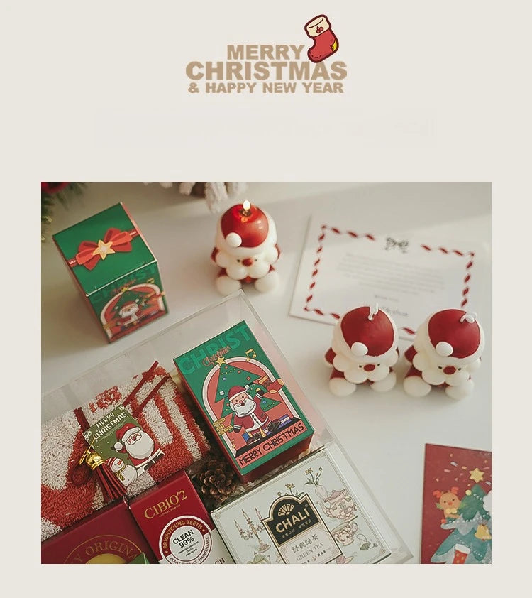 Christmas-themed products including small boxes and candles on a white surface with 'Merry Christmas & Happy New Year' text.