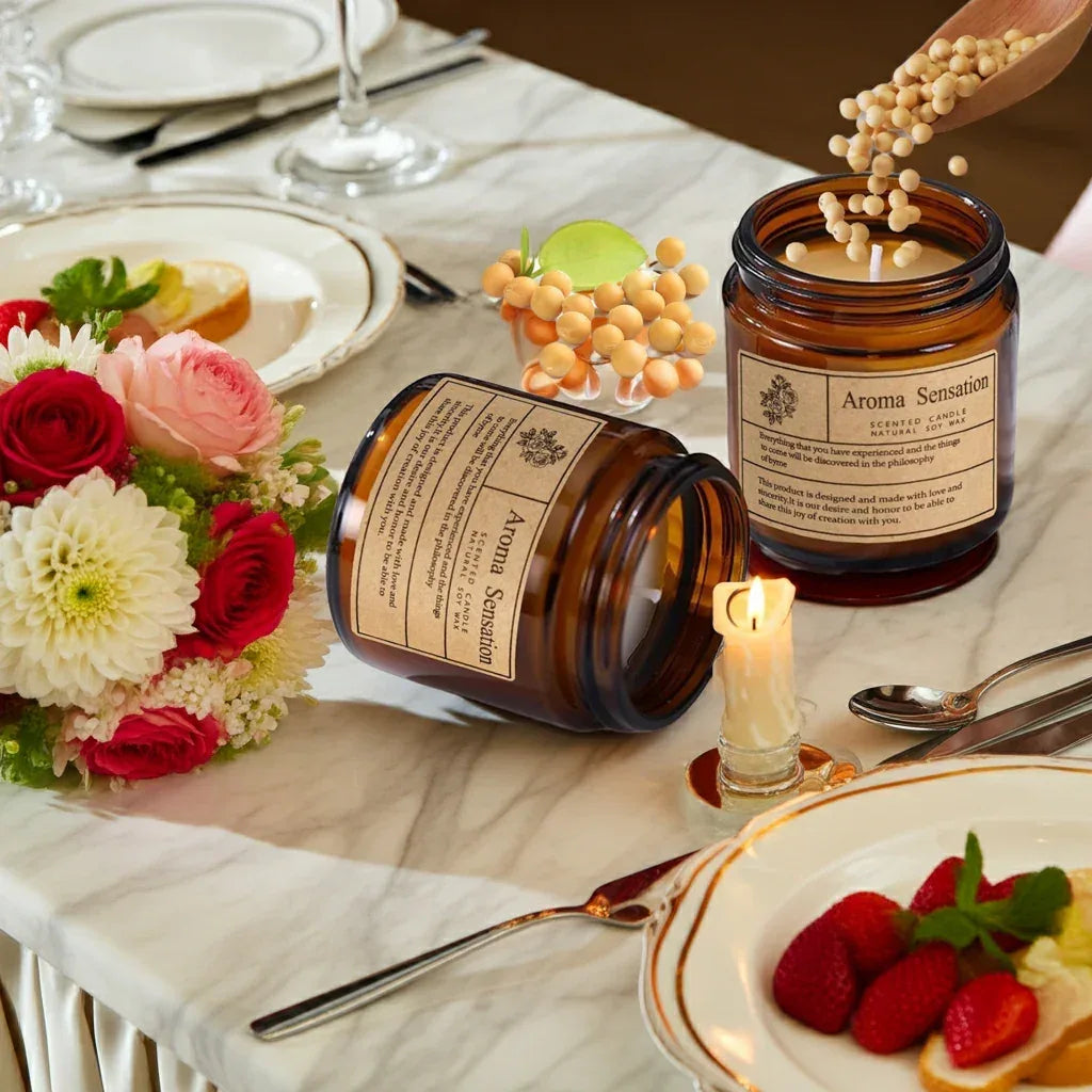 Aromatic Sensation candle on a dining table with flowers and strawberries, creating a cozy ambiance.