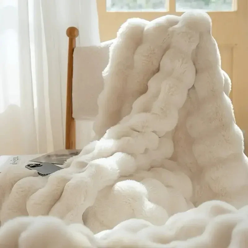 Cozy White Faux Fur Blanket draped over a chair, perfect for warmth and style.
