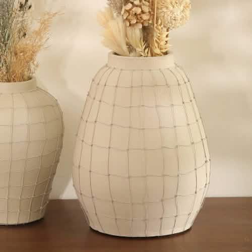 Decorative ceramic vase with a textured grid pattern, perfect for floral arrangements.