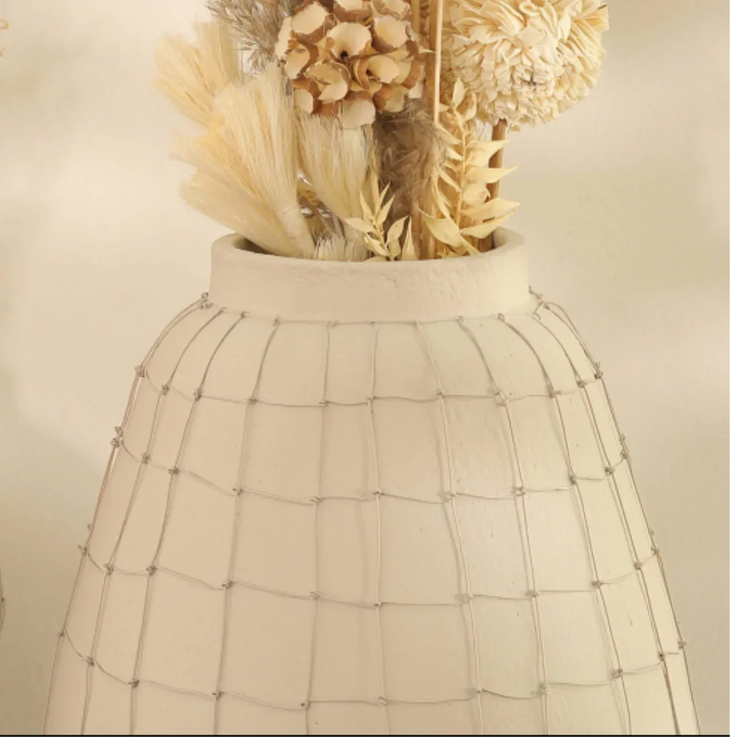 Decorative vase with dried flowers and natural textures, perfect for home decor.