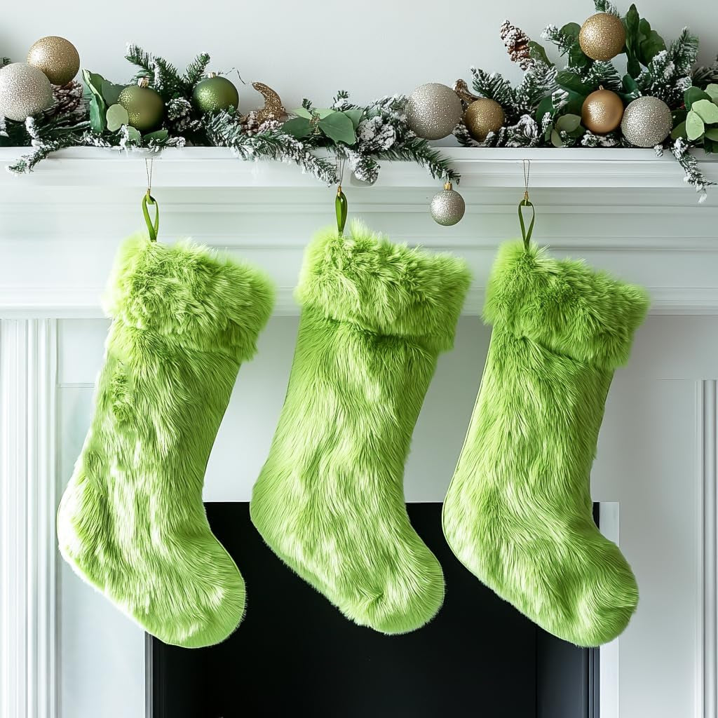 Three green fuzzy stockings hanging on a fireplace mantle with Christmas decorations.